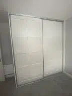 2 door sliding wardrobe with twin caraway panels in white with brushed silver frames, fitted in Thirsk